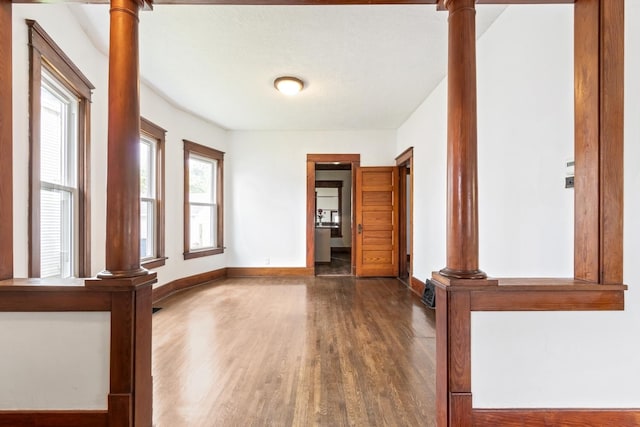 1006 W 1st St, Dixon, IL 61021 - empty room with wood finished floors, baseboards, and ornate columns