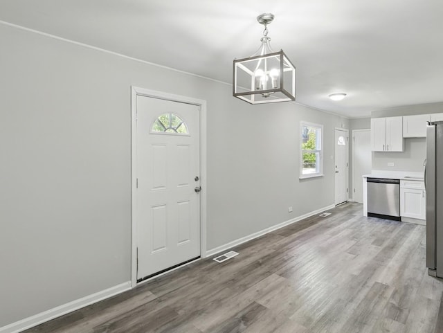 17704 Grandview Dr, Hazel Crest, IL 60429 - unfurnished dining area featuring plenty of natural light, a chandelier, light wood finished floors, and baseboards