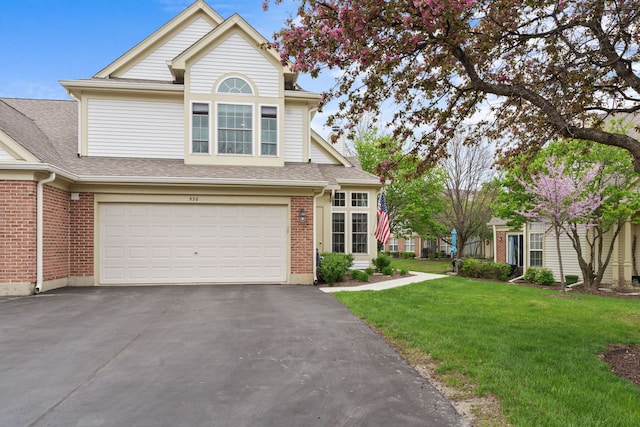538 Pembrook Ct S, Crystal Lake, IL 60014 - view of front of house with driveway, a front lawn, a garage, brick siding, and a shingled roof