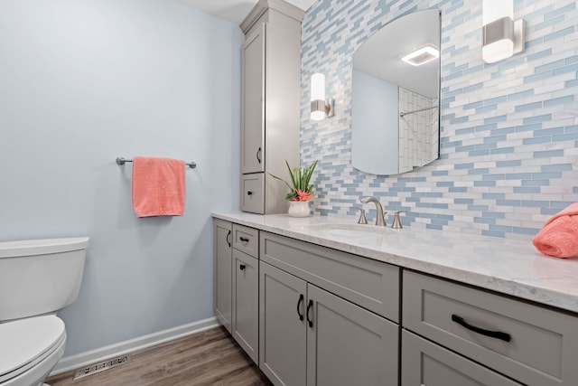 538 Pembrook Ct S, Crystal Lake, IL 60014 - full bath with vanity, toilet, wood finished floors, tasteful backsplash, and baseboards