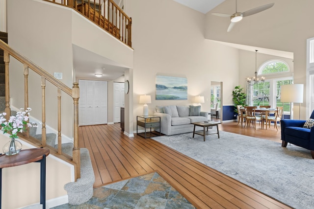 538 Pembrook Ct S, Crystal Lake, IL 60014 - living room with a towering ceiling, a chandelier, wood-type flooring, stairs, and ceiling fan