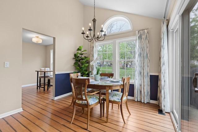 538 Pembrook Ct S, Crystal Lake, IL 60014 - dining room featuring vaulted ceiling, light wood-type flooring, baseboards, and a chandelier