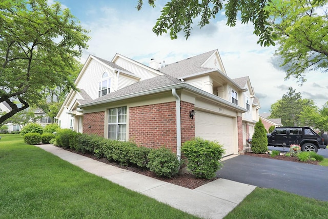 339 Ashford Cir Unit 1, Bartlett, IL 60103 - view of side of home with brick siding, asphalt driveway, roof with shingles, and a lawn