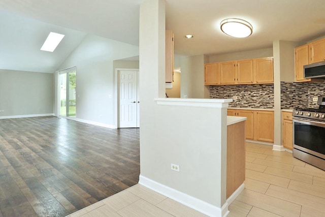 339 Ashford Cir Unit 1, Bartlett, IL 60103 - kitchen featuring light brown cabinets, appliances with stainless steel finishes, decorative backsplash, light countertops, and light wood-type flooring