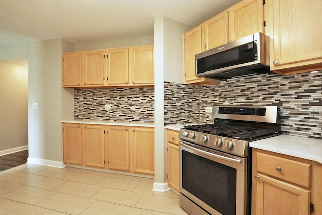 339 Ashford Cir Unit 1, Bartlett, IL 60103 - kitchen with stainless steel appliances, light brown cabinets, light countertops, and tasteful backsplash