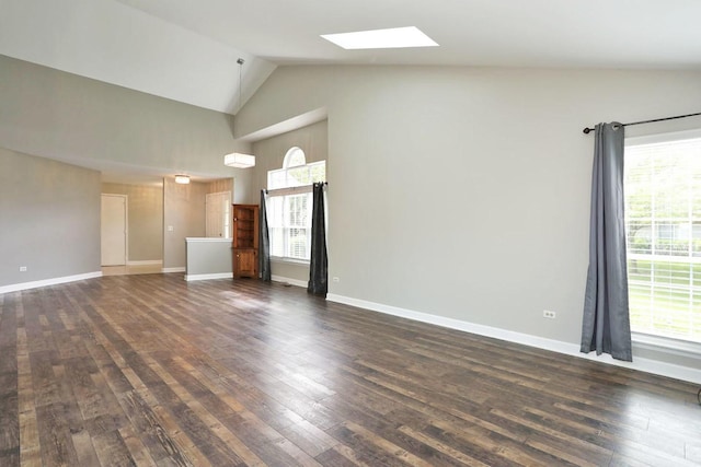 339 Ashford Cir Unit 1, Bartlett, IL 60103 - unfurnished living room featuring a skylight, healthy amount of natural light, dark wood finished floors, high vaulted ceiling, and baseboards