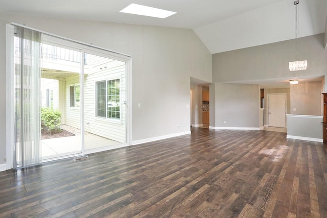 339 Ashford Cir Unit 1, Bartlett, IL 60103 - unfurnished living room featuring a skylight, high vaulted ceiling, dark wood-style floors, and baseboards