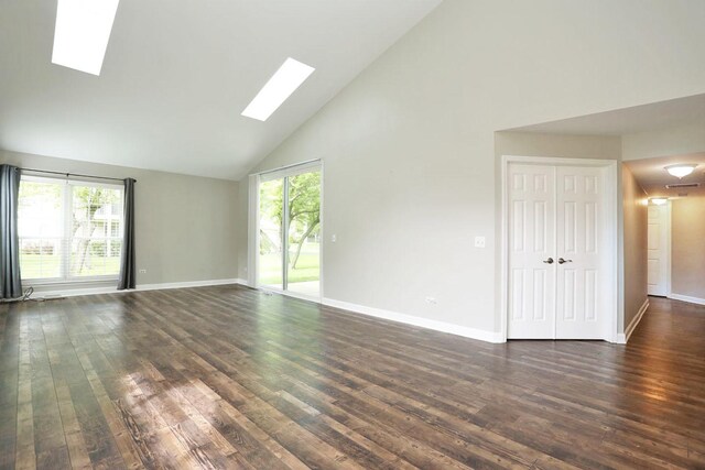 339 Ashford Cir Unit 1, Bartlett, IL 60103 - empty room with a skylight, high vaulted ceiling, plenty of natural light, dark wood finished floors, and baseboards
