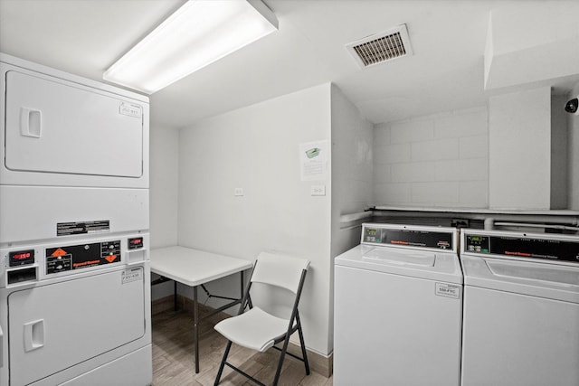 222 E Pearson St Unit 1504, Chicago, IL 60611 - communal laundry room with stacked washing machine and dryer and light wood-style flooring