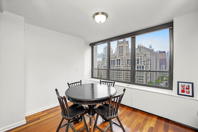 222 E Pearson St Unit 1504, Chicago, IL 60611 - dining area featuring a skyline view and wood finished floors