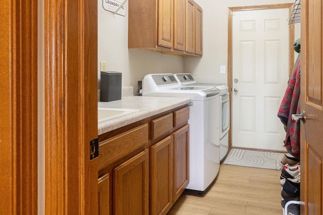 5775 S Indian Trl, Rochelle, IL 61068 - laundry room featuring washing machine and dryer, cabinet space, and light wood-type flooring