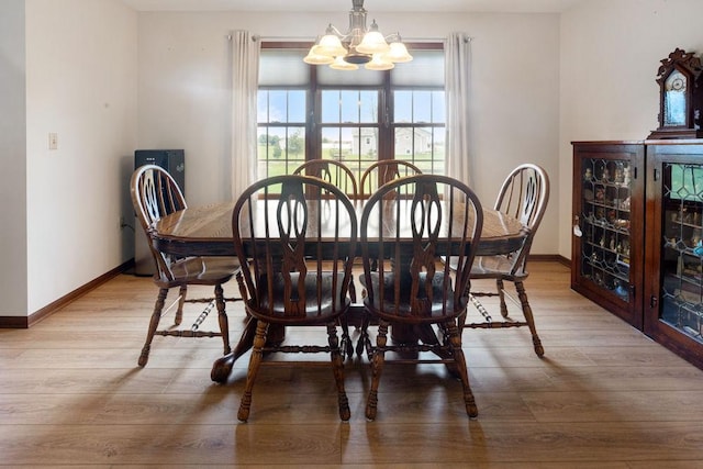 5775 S Indian Trl, Rochelle, IL 61068 - dining area featuring a chandelier, wood finished floors, and baseboards