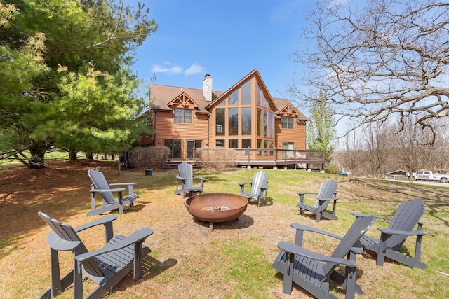 10A52 Cardinal Ct, Apple River, IL 61001 - back of property with a fire pit, a chimney, a deck, and a lawn