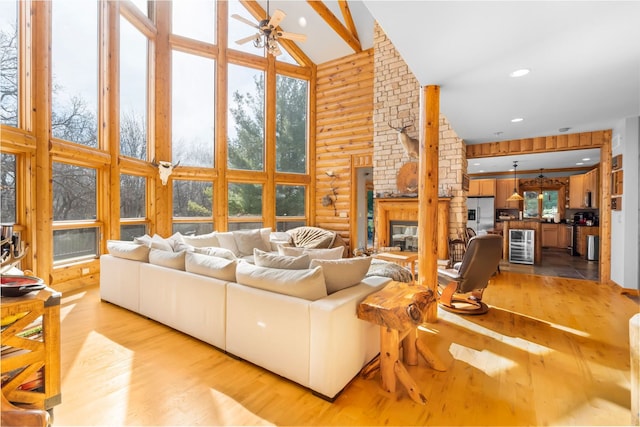 10A52 Cardinal Ct, Apple River, IL 61001 - living room with high vaulted ceiling, a ceiling fan, light wood-style floors, a brick fireplace, and healthy amount of natural light