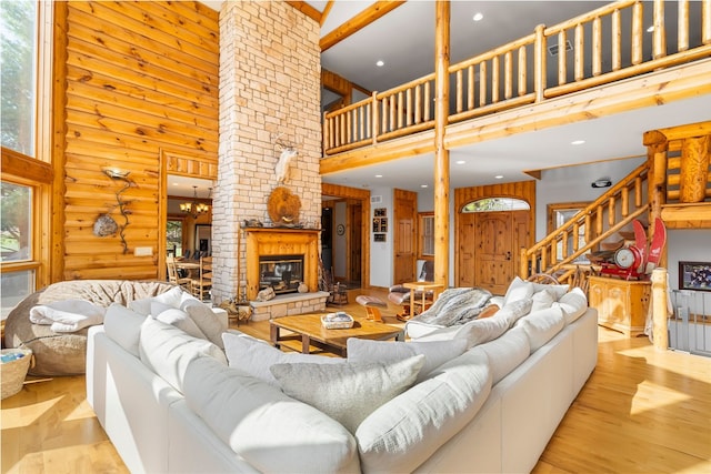 10A52 Cardinal Ct, Apple River, IL 61001 - living room with a high ceiling, wood finished floors, a fireplace, recessed lighting, and stairs