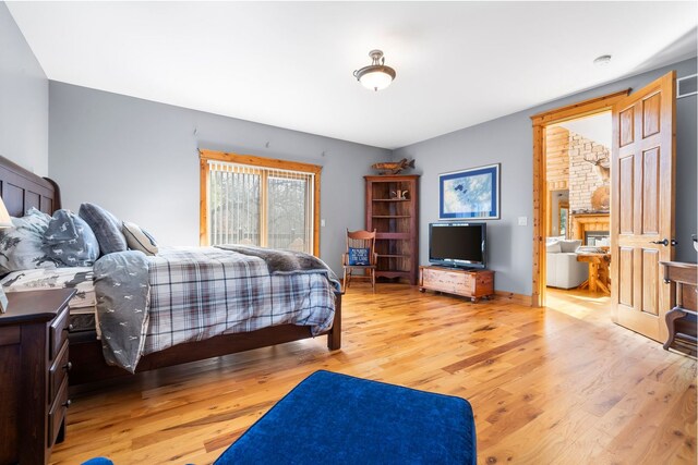 10A52 Cardinal Ct, Apple River, IL 61001 - bedroom with light wood-style flooring and a glass covered fireplace