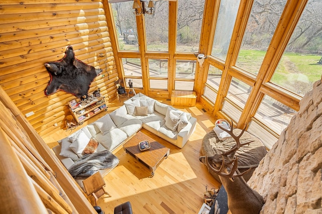 10A52 Cardinal Ct, Apple River, IL 61001 - living room featuring wood finished floors, a chandelier, and log walls