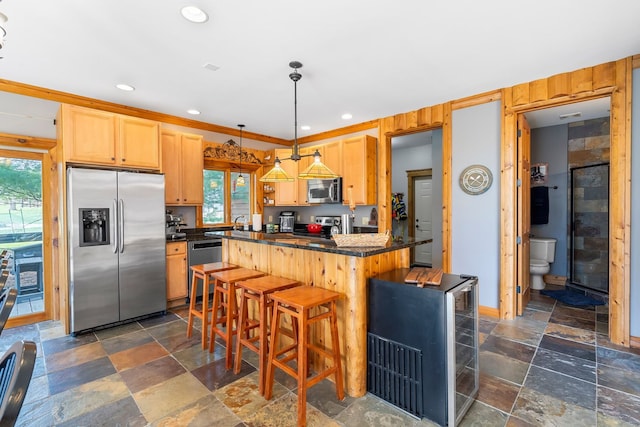 10A52 Cardinal Ct, Apple River, IL 61001 - kitchen with stainless steel appliances, dark countertops, stone tile flooring, decorative light fixtures, and recessed lighting