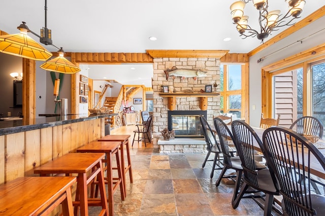 10A52 Cardinal Ct, Apple River, IL 61001 - dining area with stone tile floors, stairway, a fireplace, a chandelier, and recessed lighting