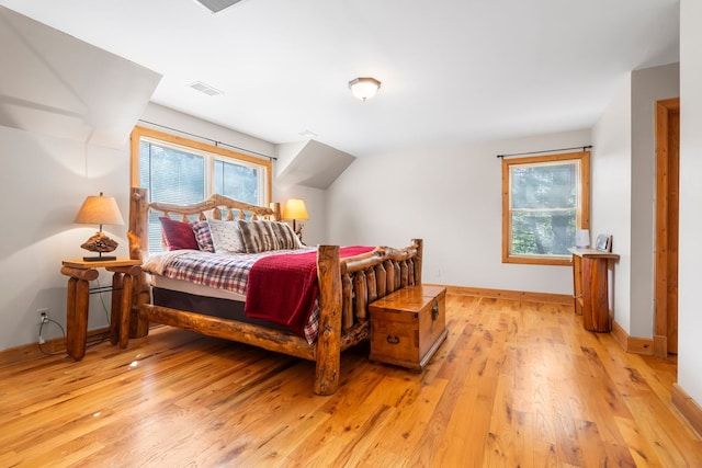 10A52 Cardinal Ct, Apple River, IL 61001 - bedroom featuring light wood finished floors, baseboards, and vaulted ceiling