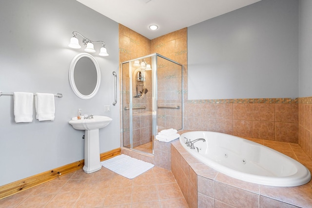 10A52 Cardinal Ct, Apple River, IL 61001 - bathroom with a jetted tub, a shower stall, baseboards, tile patterned flooring, and a sink