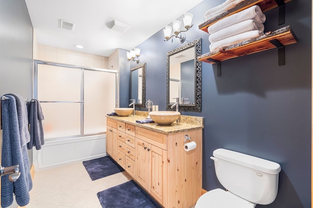 10A52 Cardinal Ct, Apple River, IL 61001 - bathroom featuring double vanity, toilet, shower / bath combination with glass door, tile patterned floors, and a decorative wall
