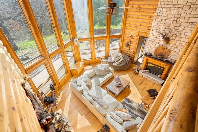 10A52 Cardinal Ct, Apple River, IL 61001 - living area featuring wood finished floors, a high ceiling, and a stone fireplace