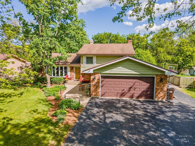 1103 Hillcrest Ave, Fox River Grove, IL 60021 - split level home with brick siding, driveway, a chimney, roof with shingles, and an attached garage