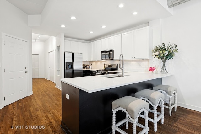 843 W Monroe St Unit 3B, Chicago, IL 60607 - kitchen with stainless steel appliances, dark wood-style flooring, light countertops, backsplash, and recessed lighting