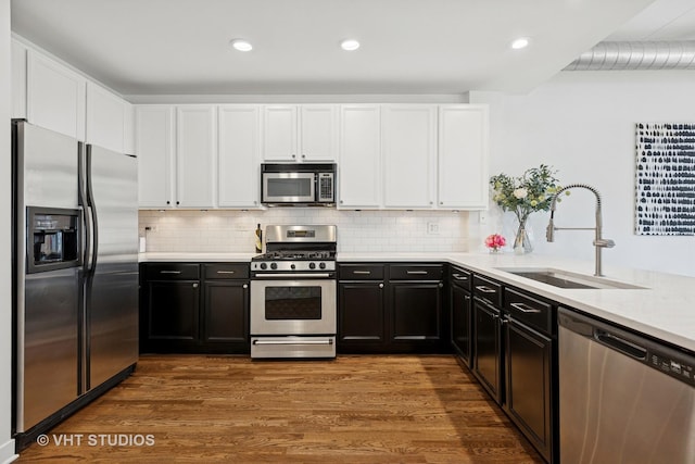 843 W Monroe St Unit 3B, Chicago, IL 60607 - kitchen featuring stainless steel appliances, a sink, white cabinets, light countertops, and recessed lighting