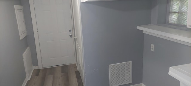 10324 S Eberhart Ave, Chicago, IL 60628 - laundry area featuring wood finished floors and baseboards