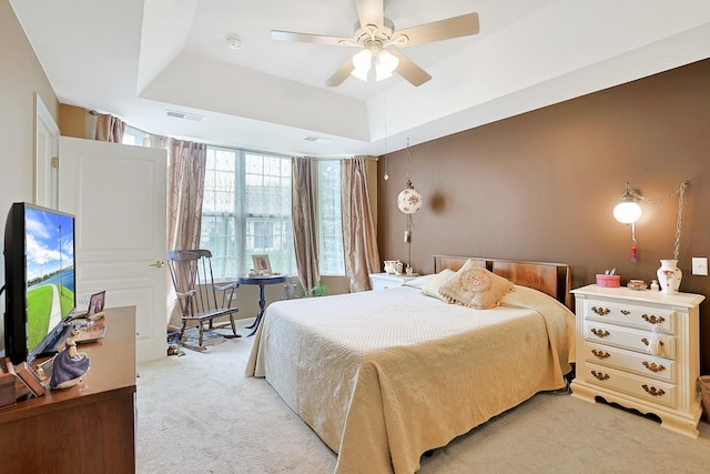 13538 Lehigh St, Huntley, IL 60142 - bedroom featuring light carpet, a tray ceiling, and a ceiling fan