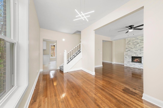 7421 S Eggleston Ave, Chicago, IL 60621 - unfurnished living room featuring stairs, wood finished floors, a fireplace, and a ceiling fan