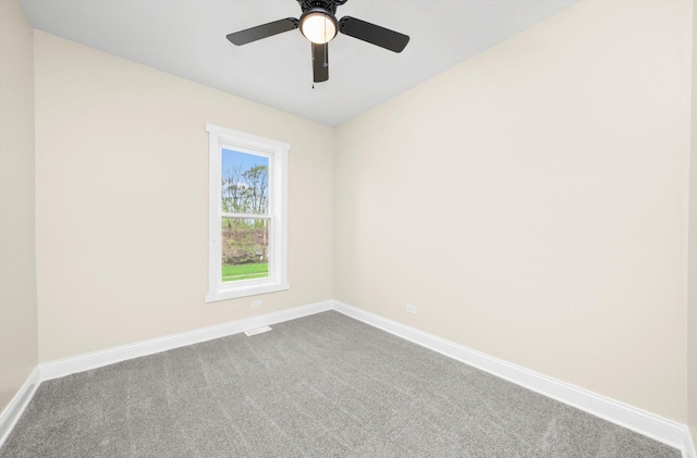 7421 S Eggleston Ave, Chicago, IL 60621 - unfurnished room featuring baseboards, dark colored carpet, and a ceiling fan