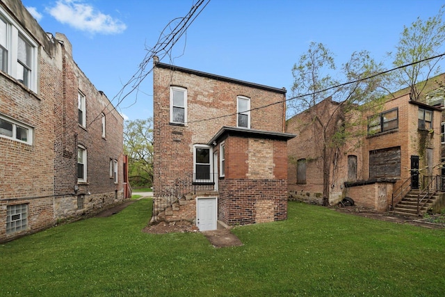 7421 S Eggleston Ave, Chicago, IL 60621 - back of property featuring brick siding, a lawn, and stairway