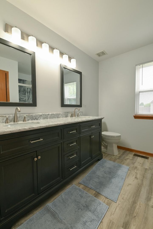 1804 Westbrook Ct, Plainfield, IL 60586 - full bath with double vanity, wood finished floors, toilet, baseboards, and a shower