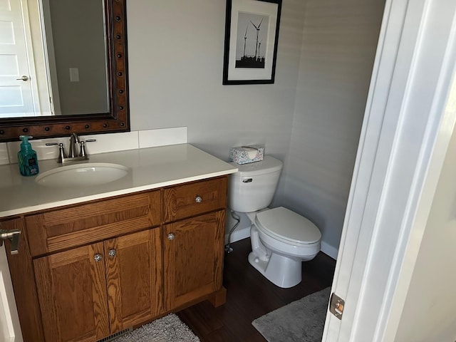 981 W Forsyth Rd, Forsyth, IL 62535 - bathroom with toilet, vanity, and wood finished floors