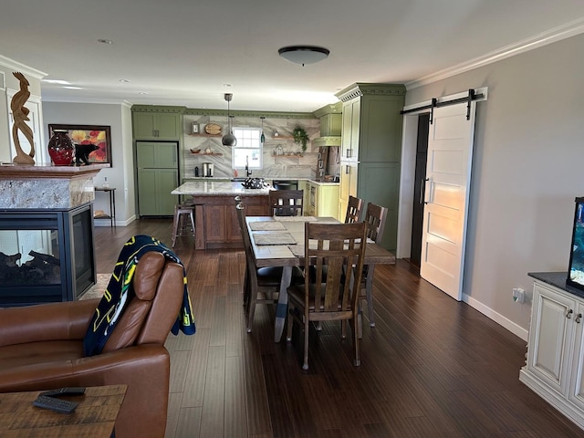 981 W Forsyth Rd, Forsyth, IL 62535 - dining room with a barn door, crown molding, baseboards, and dark wood-style floors