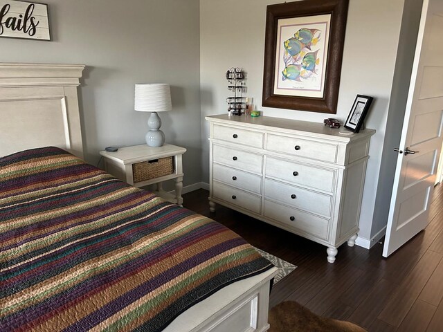 981 W Forsyth Rd, Forsyth, IL 62535 - bedroom with baseboards and dark wood-style flooring