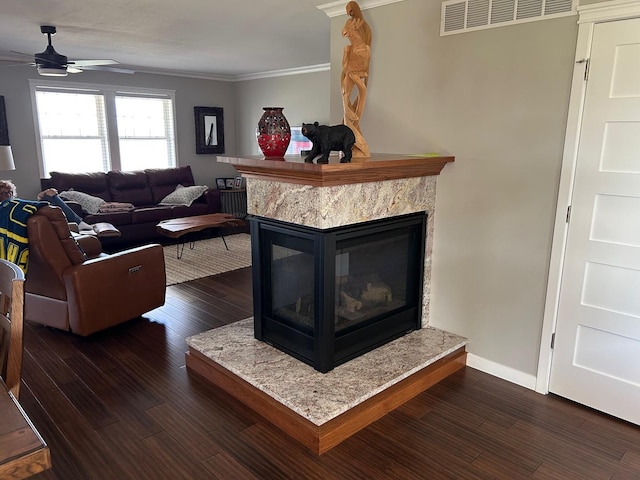 981 W Forsyth Rd, Forsyth, IL 62535 - living area with a premium fireplace, dark wood-style flooring, a ceiling fan, crown molding, and baseboards
