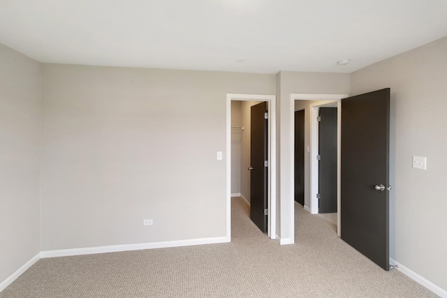 22429 Karlov Ave, Richton Park, IL 60471 - unfurnished bedroom with light colored carpet, a walk in closet, and baseboards