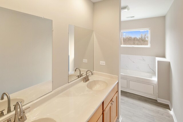 22429 Karlov Ave, Richton Park, IL 60471 - full bath with double vanity, a garden tub, and wood finished floors