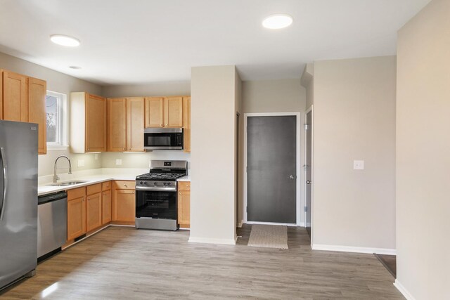 22429 Karlov Ave, Richton Park, IL 60471 - kitchen with appliances with stainless steel finishes, a sink, light wood-style flooring, and light countertops
