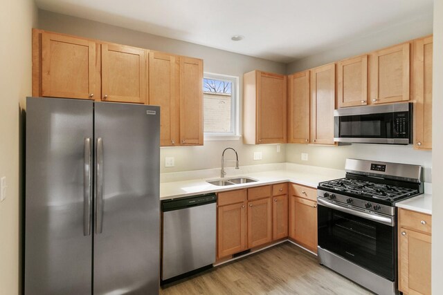 22429 Karlov Ave, Richton Park, IL 60471 - kitchen featuring appliances with stainless steel finishes, a sink, light brown cabinets, light countertops, and light wood-style floors
