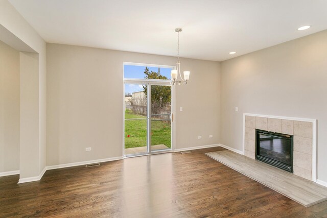 22429 Karlov Ave, Richton Park, IL 60471 - unfurnished living room featuring dark wood finished floors, a tile fireplace, baseboards, recessed lighting, and a chandelier