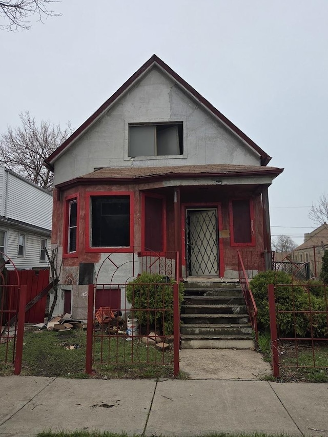 114 W 108th Pl, Chicago, IL 60628 - view of front of home featuring covered porch, a fenced front yard, and stucco siding