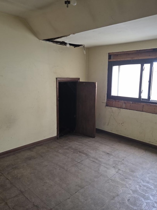 114 W 108th Pl, Chicago, IL 60628 - spare room featuring baseboards and lofted ceiling