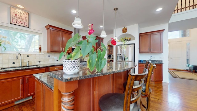 731 W Kenilworth Ave, Palatine, IL 60067 - kitchen with a sink, a kitchen island, dark wood finished floors, backsplash, and stainless steel fridge