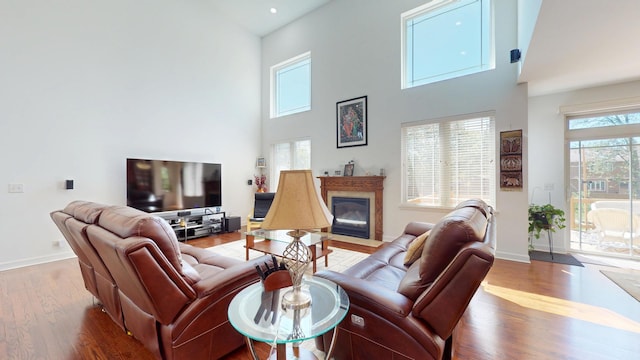 731 W Kenilworth Ave, Palatine, IL 60067 - living room with wood finished floors, a towering ceiling, a fireplace with flush hearth, and baseboards