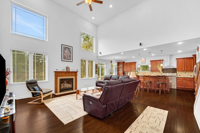 731 W Kenilworth Ave, Palatine, IL 60067 - living room featuring ceiling fan, dark wood-style floors, a fireplace with flush hearth, a towering ceiling, and recessed lighting